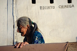 Ignacia Quimi camina frente a su casa tras haber tendido la ropa, en la comunidad de La Ciénega, provincia de Santa Elena. Foto: Santiago Arcos Ignacia Quimi camina frente a su casa tras haber tendido la ropa, en la comunidad de La Ciénega, provincia de Santa Elena. Foto: Santiago Arcos